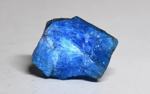 A piece of translucent light blue apatite on a white background. Natural mineral Stock Photos