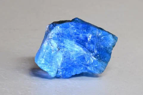 A piece of translucent light blue apatite on a white background. Natural mineral Stock Photos