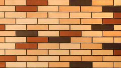 A piece of wall made of multicolored brick. Stock Photos