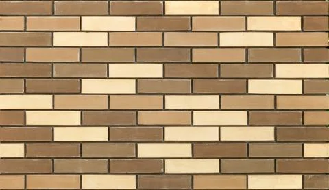 A piece of wall made of multicolored brick. Stock Photos
