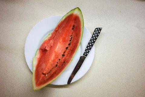 A piece of watermelon on the kitchen table 스톡 사진
