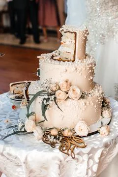Piece of wedding cake with candles on the table Stock Photos