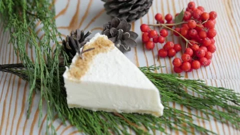 A piece of white cheesecake with pine nuts. cheesecake over which the bumps fly Stock-Footage 147475556