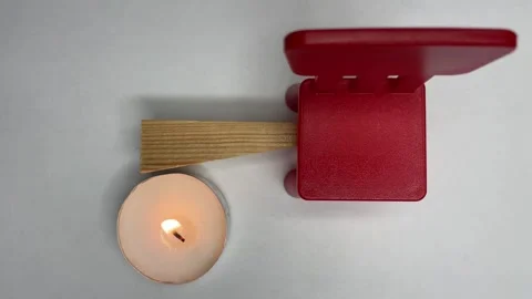 Piece of wood the wind blows on a candle red chair Video stock 252188742