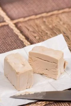 Piece of yeast on the table Stock Photos