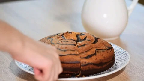 Piece of ''Zebra'' cake with chocolate glaze. Video stock 84197849