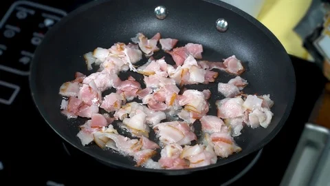 Pieces of bacon are fried in a pan Stock Footage 125803960