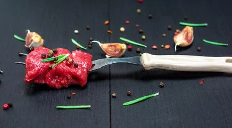 Pieces of beef strung on a kitchen fork Stock Photos