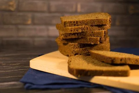 Pieces of black bread on the board Stock Photos