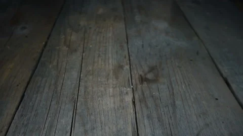 Pieces of black bread falling in slow motion on a dark wooden Stock Footage 131009200