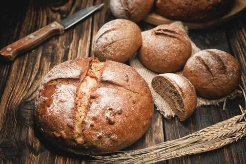 Pieces of bread on a board with shallow depth of field Stock Photos