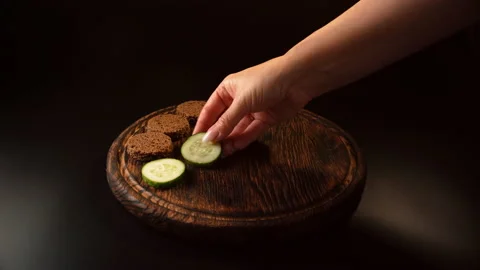 Pieces of bread, cheese, cucumber, ham, ham, put on a tray, cooking canapes Stock Footage