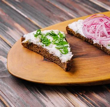 Pieces of bread with delicious lard with red and green onions Stock Photos