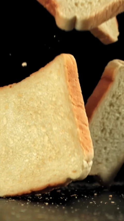 Pieces of bread fall on the table. Filmed on a high-speed camera at 1000 fps Stock Footage 335365791