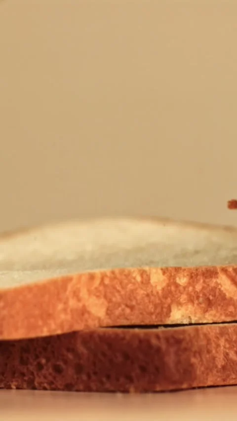 Pieces of bread fall on the table. Filmed on a high-speed camera at 1000 fps Stock Footage 335373280