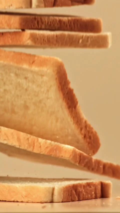 Pieces of bread fall on the table. Filmed on a high-speed camera at 1000 fps Stock Footage 335373357