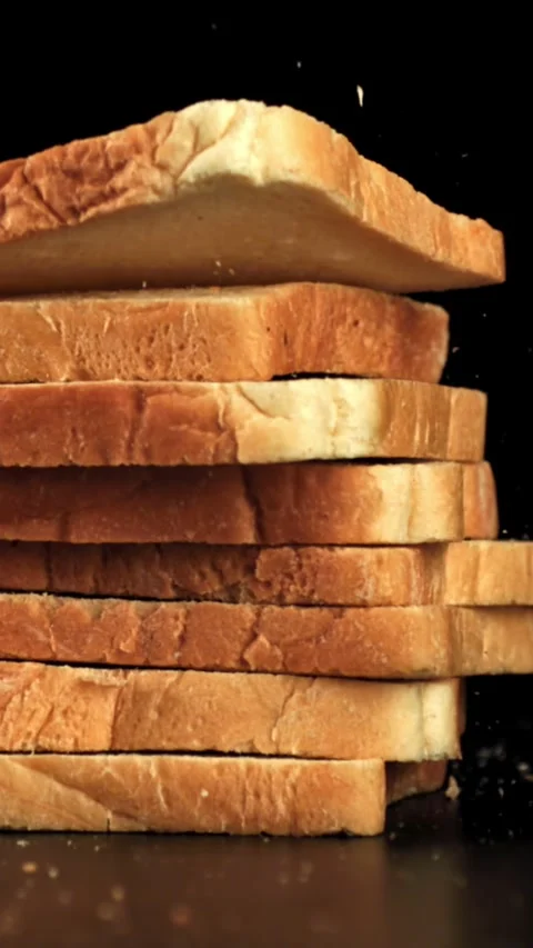 Pieces of bread fall on the table. Filmed on a high-speed camera at 1000 fps Stock Footage 335376014