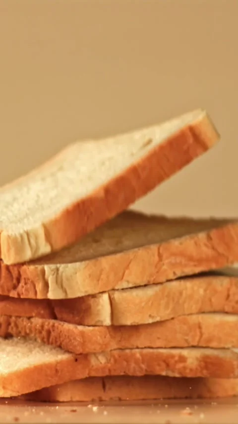 Pieces of bread fall on the table. Filmed on a high-speed camera at 1000 fps Stock Footage 335376423