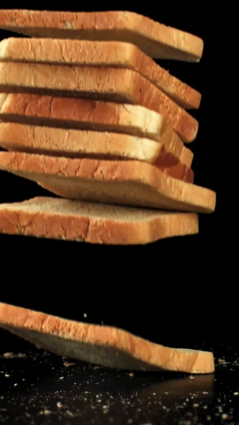 Pieces of bread fall on the table. Filmed on a high-speed camera at 1000 fps Stock Footage 335378238