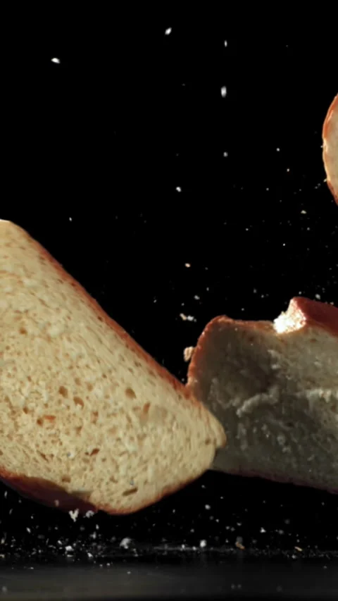 Pieces of bread falling on a black background. Filmed on a high-speed camera at Stock Footage 335363974