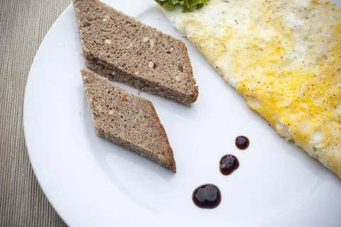 Pieces of bread with omelette Stock Photos
