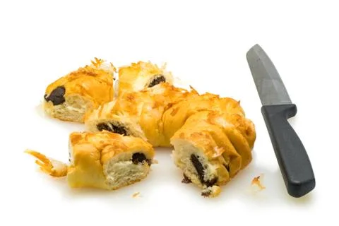 Pieces of bread pudding with coconut and knife on white background Stock Photos