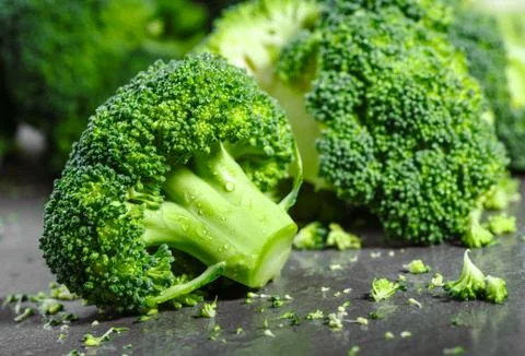 Pieces of broccoli, rustic style, old wooden background Stock Photos