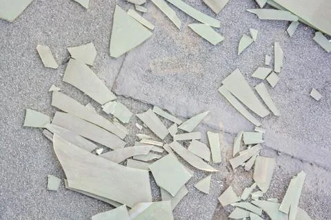 Pieces of broken plastic sheet on ground Stock Photos
