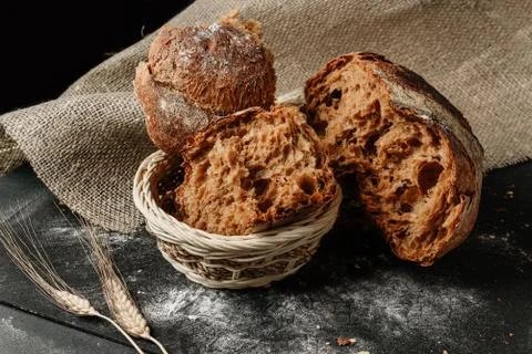 Pieces of broken rustic bread in a basket Stock Photos