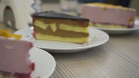 Pieces of cakes on the table, camera passage. office sweets, different flavors Stock Footage 219471437