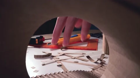 Pieces of cardboard fall on the table. Stock Footage 142932168