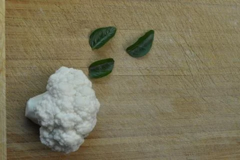 Pieces of cauliflower on wooden background. Stock Photos