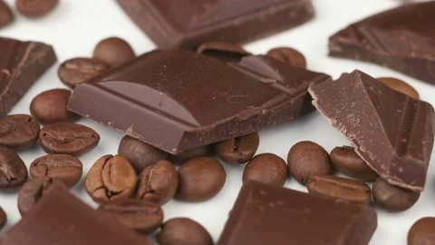 Pieces of chocolate and coffee beans on a white isolate background Video stock 153756643