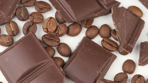 Pieces of chocolate and coffee beans on a white isolate background Video stock 153756658