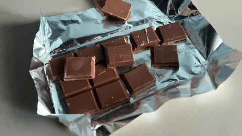 Pieces of the chocolate bar are on the table Stock Footage 265023256