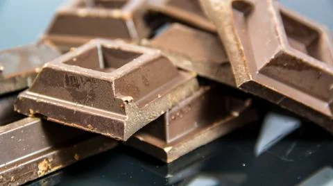 Pieces of chocolate bar on neutral background Stock Photos