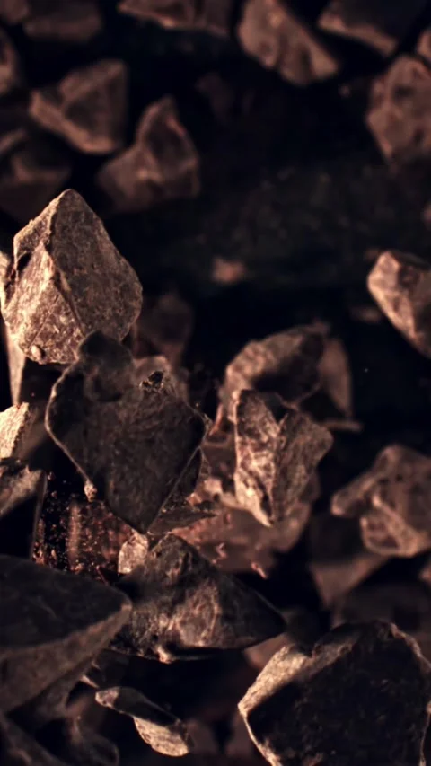Pieces of chocolate fall down into the pile. Filmed is slow motion 1000 fps Stock Footage 335292089