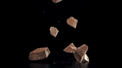 Pieces of chocolate fall on the table. Filmed on a high-speed camera at 1000 fps Stock Footage 309096222