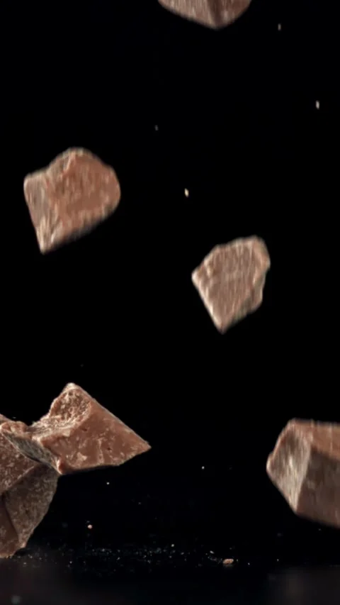 Pieces of chocolate fall on the table. Filmed on a high-speed camera at 1000 fps Stock Footage 335365507