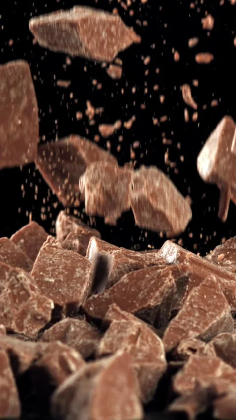 Pieces of chocolate fall on the table. Filmed on a high-speed camera at 1000 fps Stock Footage 335365933
