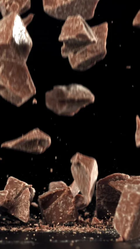 Pieces of chocolate fall on the table. Filmed on a high-speed camera at 1000 fps Stock Footage 335371462