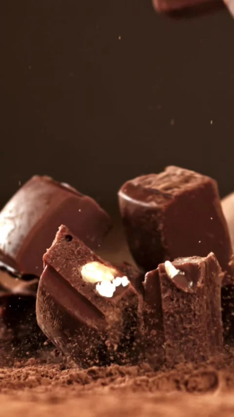Pieces of chocolate fall on the table. Filmed on a high-speed camera at 1000 fps Stock Footage 335380617