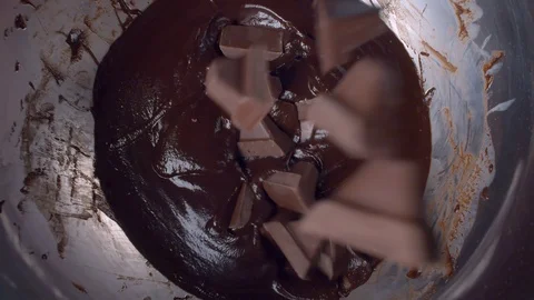 Pieces of chocolate falling into liquid chocolate Stock Footage 123311189