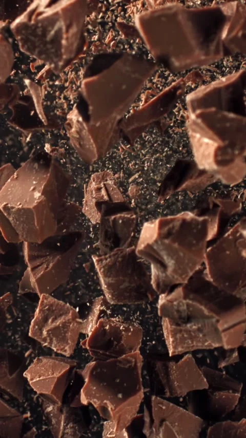 Pieces of chocolate fly up and fall down. Filmed on a high-speed camera at 1000 Stock Footage 335368615