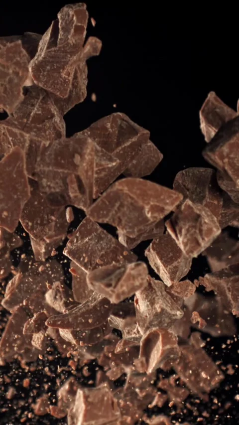Pieces of chocolate fly up and fall down. Filmed on a high-speed camera at 1000 Stock Footage 335370535
