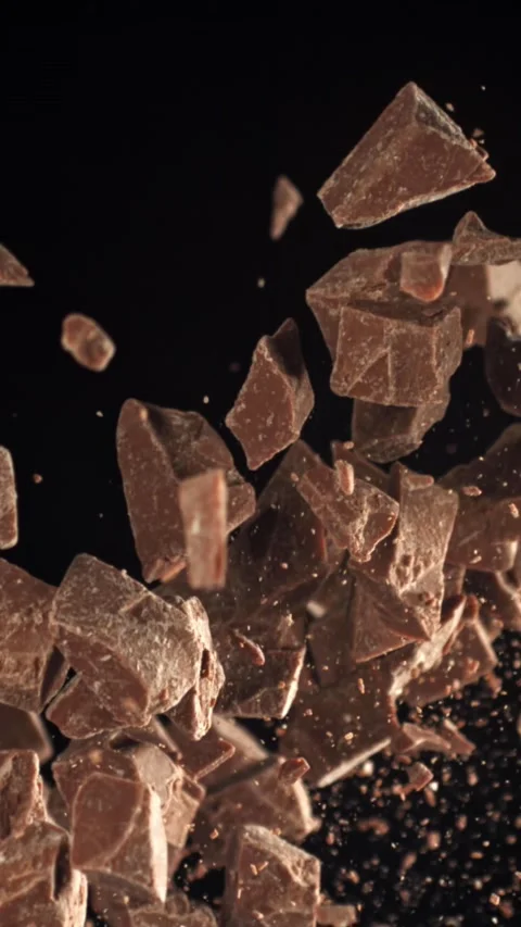 Pieces of chocolate fly up and fall down. Filmed on a high-speed camera at 1000 Stock Footage 335371333