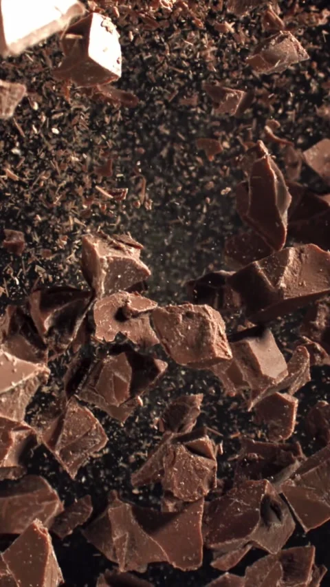 Pieces of chocolate fly up and fall down. Filmed on a high-speed camera at 1000 Stock Footage 335373911
