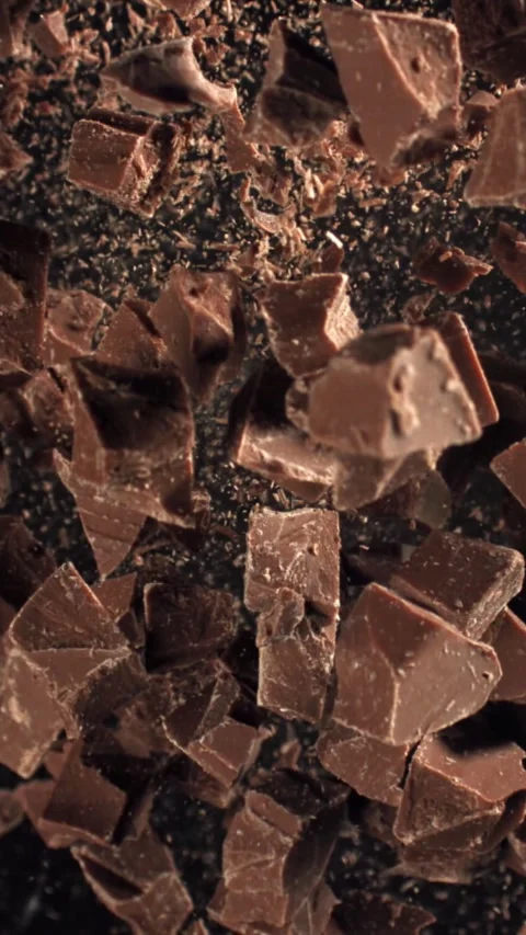 Pieces of chocolate fly up and fall down. Filmed on a high-speed camera at 1000 Stock Footage 335374237