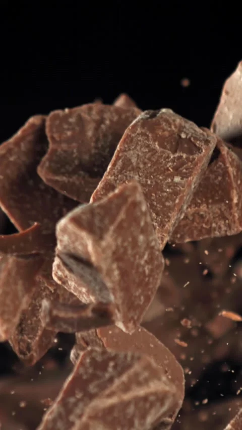 Pieces of chocolate fly up and fall down. Filmed on a high-speed camera at 1000 Stock Footage 335374593