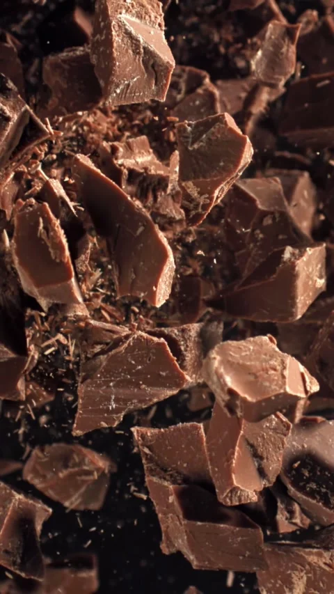 Pieces of chocolate fly up and fall down. Filmed on a high-speed camera at 1000 Stock Footage 335374662